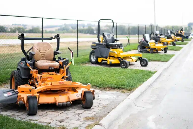 Used lawn mowers lined up outside Ty’s Outdoor Power dealership.