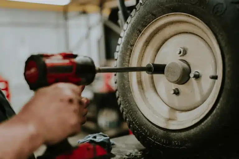 Technician repairing tire during commercial lawn mower maintenance