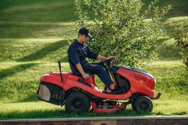 red riding lawn mower operated by professional